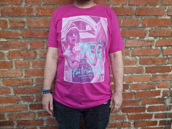 product image: pink t-shirt with pink print, blue text "peg the patriarchy"